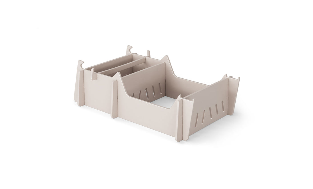 A beige, rectangular plastic organizer with two compartments and side slots features raised sides and hooks for stacking, resembling the Signature Chair Riser by Ledge Lounger. Its showcased on a plain white background.