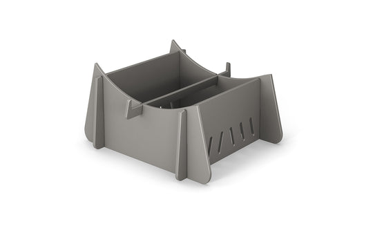 The Signature Chaise Riser by Ledge Lounger is a gray, modern geometric organizer with angled panels and vertical slots. Its minimalist style neatly stores papers or utensils, ideal for indoor and outdoor use.