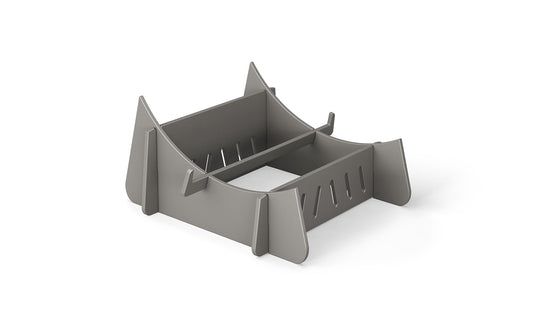 The Signature Chaise Riser by Ledge Lounger is a gray, rectangular plastic holder with divided sections and angled sides, ideal for organizing or stacking. It’s perfect for an outdoor day with vertical slots designed for ventilation or drainage.