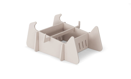 A beige, rectangular modular desk organizer with open compartments and vertical dividers, made from flat interlocking panels—perfect for organizing paperwork after a day relaxing on Ledge Lounger Signature Chaise Deep Riser.