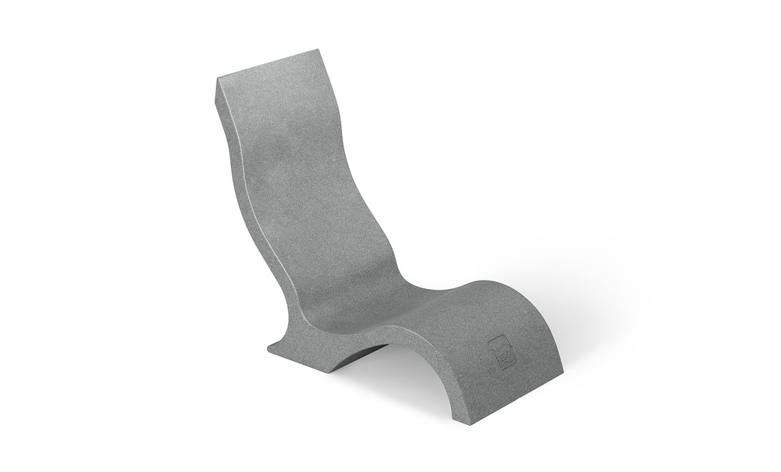 The Signature Chair by Ledge Lounger is a modern, minimalist gray lounger with a sleek, wave-like design. Made from smooth material, it features a continuous flow from the seat to backrest and base, perfect for your outdoor oasis or as an in-pool lounger.