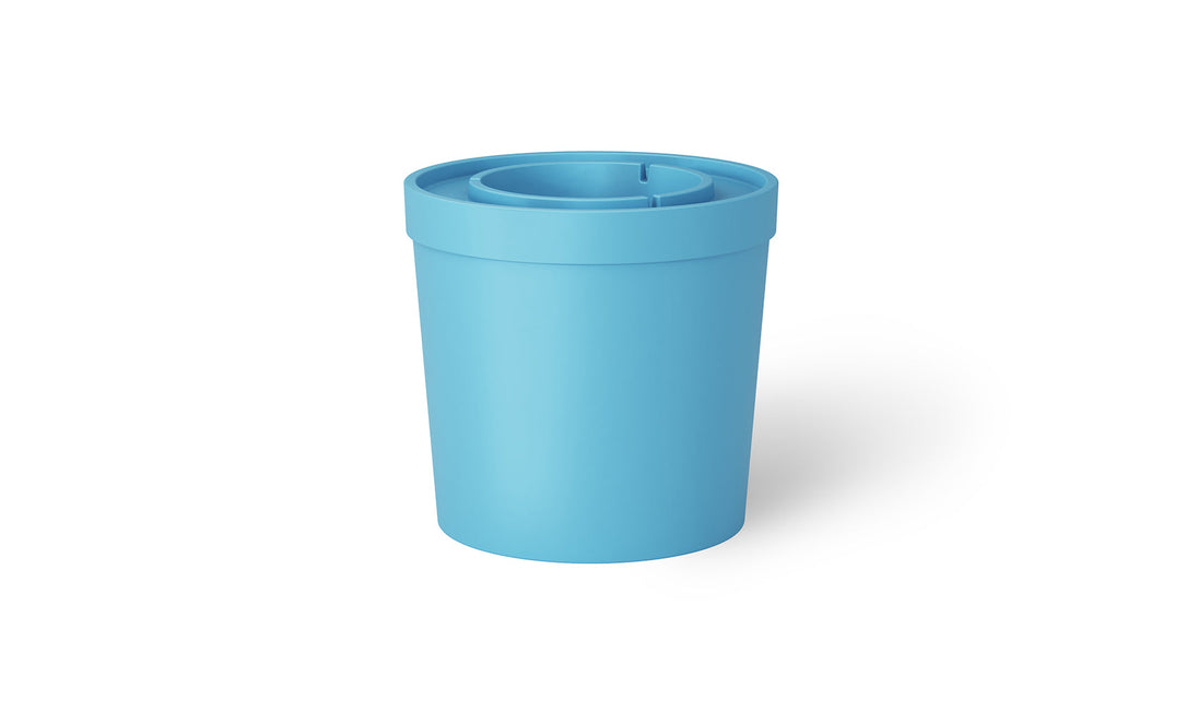The Signature Ice Basin by Ledge Lounger is a light blue cylindrical container with a rounded lid on a plain white background. The elegant design resembles an ice basin, and the lid has a groove indicating it is removable for easy access.