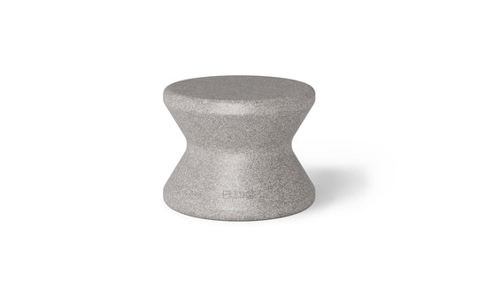 The Signature Standard Side Table by Ledge Lounger is a gray hourglass-shaped stool with a smooth surface, ideal for in-pool use. It complements any sun shelf setting and is set against a plain white background.