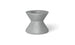 A small, hourglass-shaped gray object with a hollow top resembles an umbrella base. Its smooth surface and symmetrical design remind one of an industrial component. Shadows imply placement on a light surface, akin to the Signature Tall Ice Bin Side Table by Ledge Lounger.