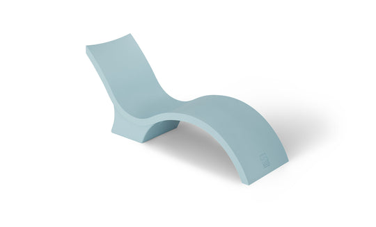 The Signature Chaise Deep by Ledge Lounger is a light blue, modern chaise lounge with a smooth, curved design and an elevated backrest. Perfect for a sun shelf or tanning ledge, its showcased against a white background for ultimate relaxation.