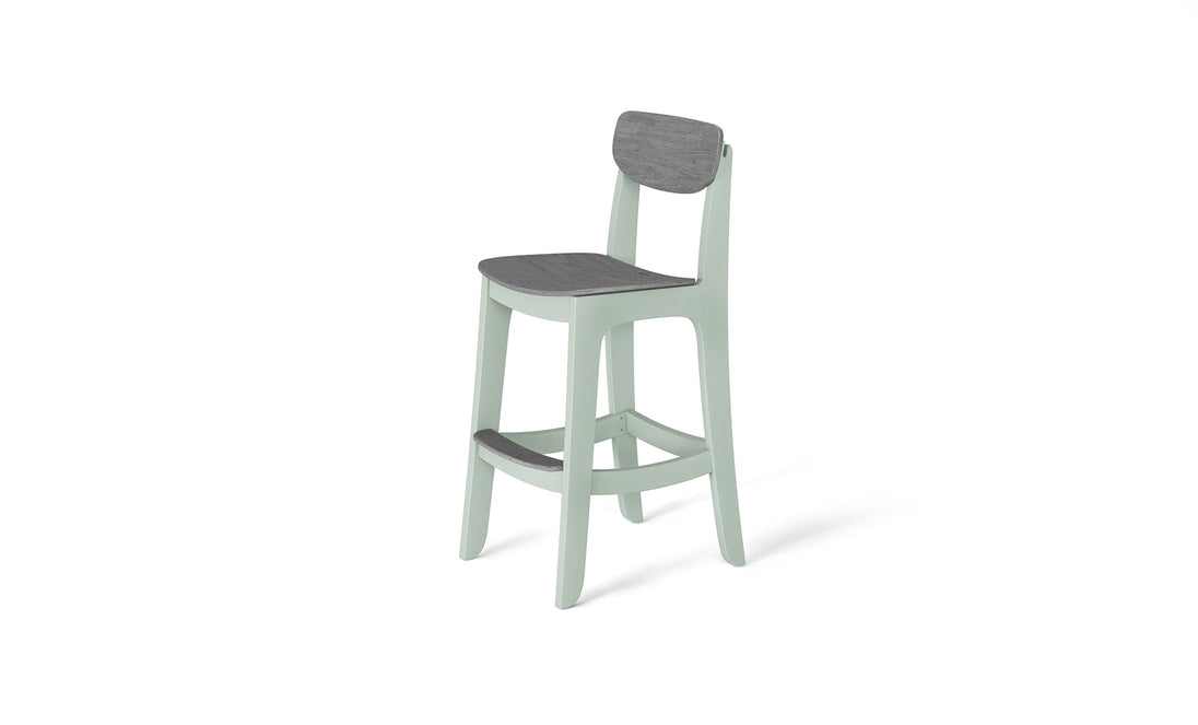 The Haven Hightop Chair by Ledge Lounger features a sleek, modern design with a light green frame, an ergonomic dark gray seat and backrest, contrasted against a white background.