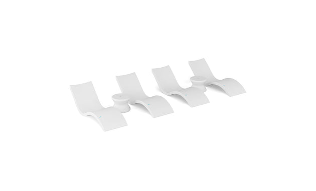 The Ledge Lounger Signature Chaise and Side Table In-Pool 6-Piece Set features modern white, wave-inspired loungers stylishly arranged on a plain background, highlighting chic pool ledge furniture.