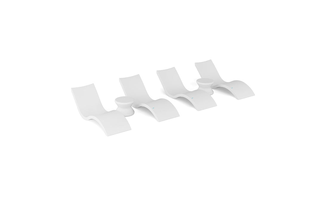Four modern, white wall hooks—each with a curved, minimalist shape and a blue dot accent—are arranged side by side, echoing the sleek style of the Ledge Lounger Signature Chaise and Side Table In-Pool 6-Piece Set.