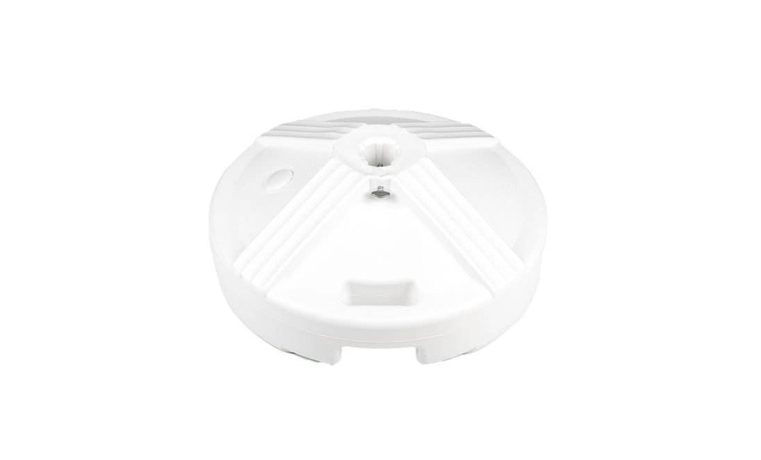 A white, circular object with radial ridges and a central hole is set against a plain background, resembling tranquility akin to an outdoor dining space. This is the Resin Coated Concrete Umbrella Base by Ledge Lounger.