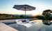 Ledge Lounger in-pool umbrella and chaises.