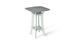 The Haven Hightop Table by Ledge Lounger is a modern square table with a grey top and light green, ergonomically curved legs. It features a small shelf below the tabletop, offering unique style and functionality as part of our patio collection.