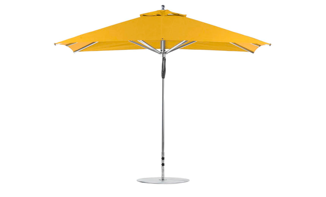 The Ledge Lounger Premier Aluminum Umbrella - 8.5 Rectangle Pulley features a wind-resistant, vibrant yellow canopy made from marine-grade fabrics with a sturdy metal pole and circular base, offering modern, durable shade for any patio or garden setting.
