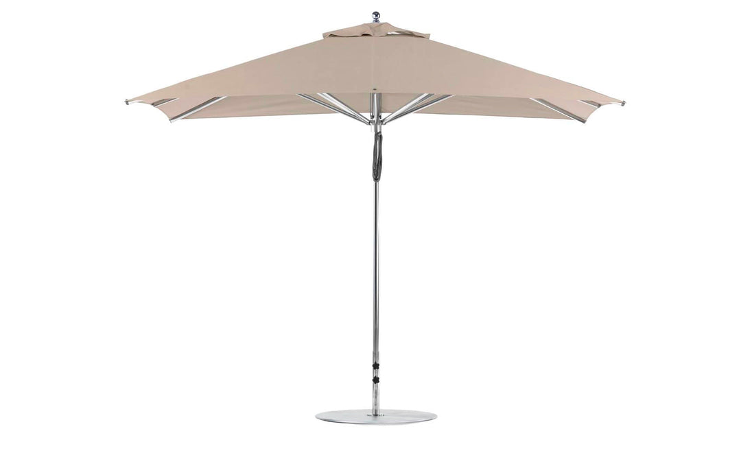 Explore the Premier Aluminum Umbrella by Ledge Lounger, an 8.5 rectangle pulley umbrella with a tan outdoor canopy made from marine-grade fabrics. Its stylish aluminum pole, circular base, and six-ribbed design provide modern flair and wind-resistant stability for your garden or poolside haven.