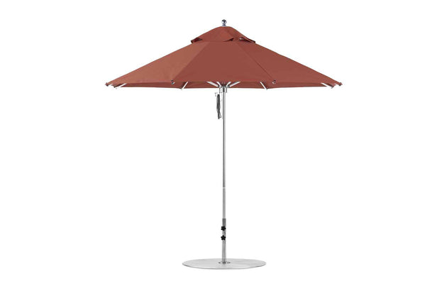 The Ledge Lounger Premier Aluminum Umbrella - 9 Octagon Pulley features a brown canopy and silver stand. Its wind-resistant, ribbed frame is crafted from marine-grade fabrics, ensuring durability. A circular base offers stability against any backdrop.