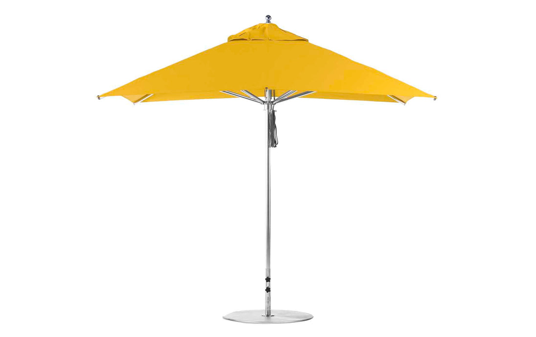 The Premier Aluminum Umbrella – 10 Square Pulley by Ledge Lounger features a yellow canopy with an aluminum pole on a round base, marine-grade fabrics, and a streamlined design that ensures wind resistance, making it ideal for outdoor spaces.