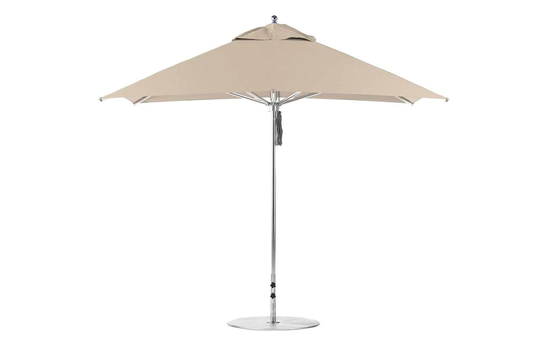 The Ledge Lounger Premier Aluminum Umbrella features a 10 square beige canopy made from marine-grade fabrics, a polished aluminum pole, and stands on a round base against a white background.