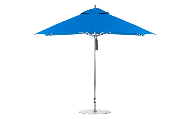 The Premier Aluminum Umbrella by Ledge Lounger features a marine-grade, wind-resistant design. This open blue 10 square umbrella stands against a white background with a sleek aluminum pole and round base, ensuring durability and style in any setting.