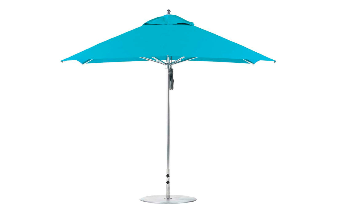 The Premier Aluminum Umbrella - 10 Square Pulley by Ledge Lounger features a vibrant turquoise canopy of marine-grade fabric on a sleek silver pole, standing open on a sturdy, flat base. Designed for wind resistance, it offers reliable protection in any outdoor environment.
