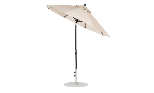 The Ledge Lounger Essential Fiberglass Umbrella, a 7.5 octagon with an auto-tilt crank, features a beige marine-grade canopy on a black pole with a round silver base, offering wind resistance and durability with side-view style.