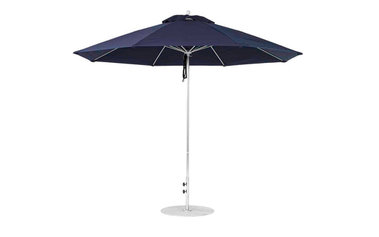 The Ledge Lounger Essential Fiberglass Umbrella, featuring an 11 octagon canopy made from marine-grade fabrics in navy blue, is supported by a sturdy white metal pole. This wind-resistant patio umbrella stands upright with a circular base for ground stability.