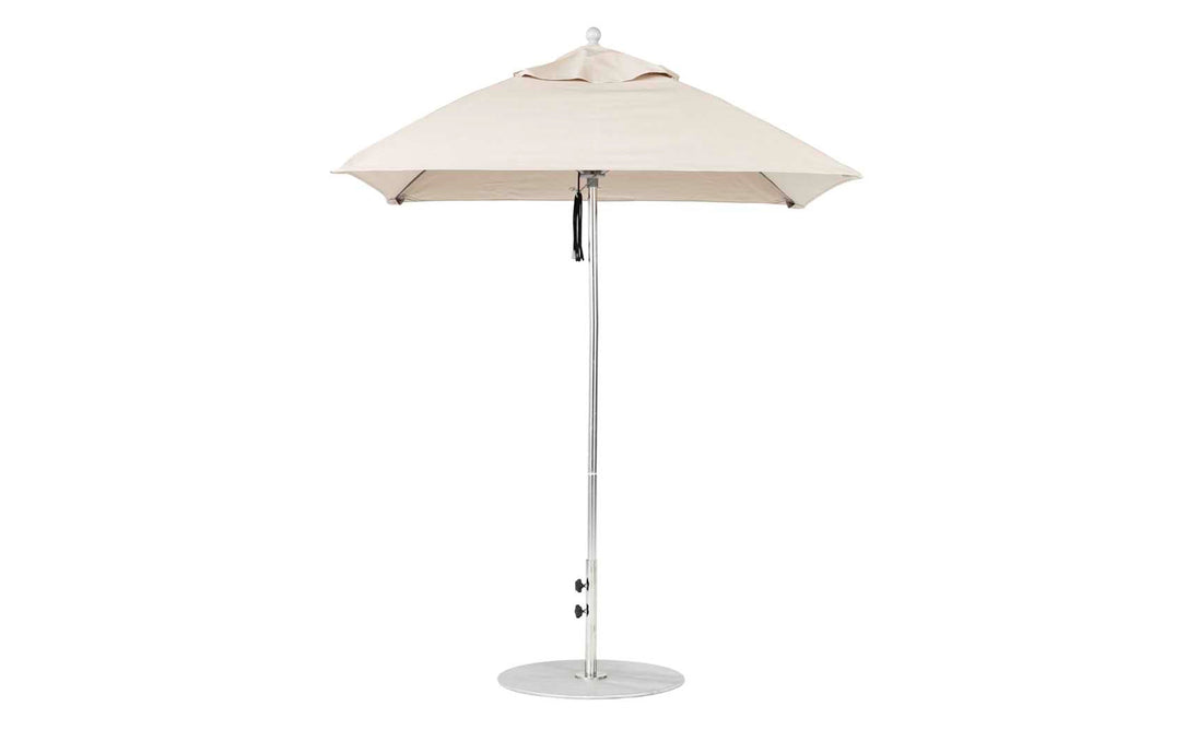 A Ledge Lounger Essential Fiberglass Umbrella - 6.5 Square Pulley in beige stands open on a white background, featuring an aluminum center pole and a round metal base that support its marine-grade fabrics for durable outdoor style.