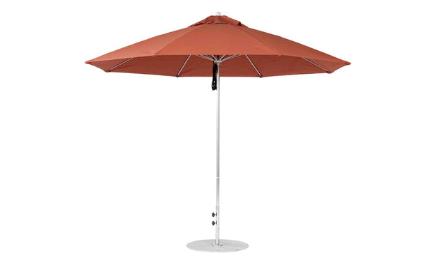 The Essential Fiberglass Umbrella by Ledge Lounger is a large, rust-colored patio umbrella featuring an 11 octagon design with a metal pole and round base. Made with marine-grade fabrics, it offers wind resistance and sleek style, perfect for outdoor use.
