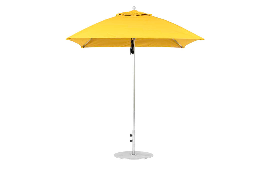 The Essential Fiberglass Umbrella - 7.5 Square Pulley by Ledge Lounger is a yellow patio umbrella with marine-grade fabric, featuring a silver pole and round base, showcased upright against a white background.