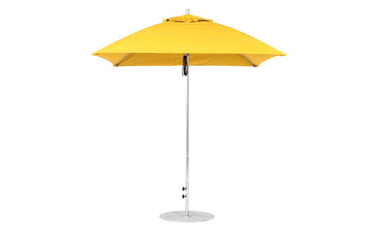 The closed yellow Essential Fiberglass Umbrella - 7.5 Square Pulley by Ledge Lounger stands on a sleek metallic pole with a round base. Built from marine-grade fabrics, its vibrant canopy is neatly folded, ideal for both in-pool and on-deck use.