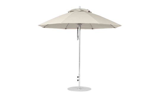 The Ledge Lounger Essential Fiberglass Umbrella, a large beige 9 octagon patio umbrella with a central pole and sturdy round base, features marine-grade fabric and modern metal structure, perfect for any garden or patio setting.
