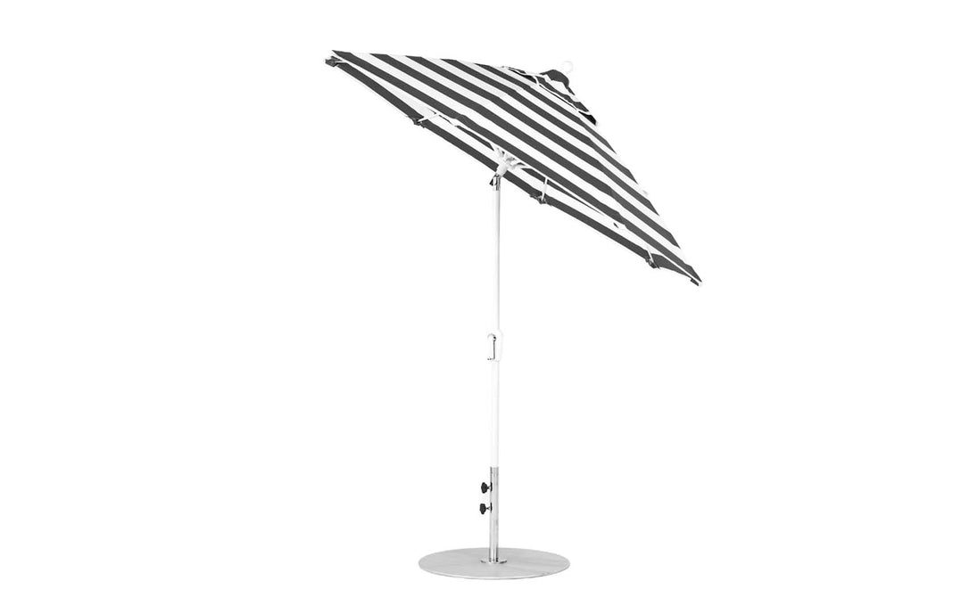 The Essential Fiberglass Umbrella by Ledge Lounger is a stylish 7.5 octagon crank auto tilt model with black and white stripes, marine-grade fabrics, and a sturdy metal pole and base, set against a plain white background.