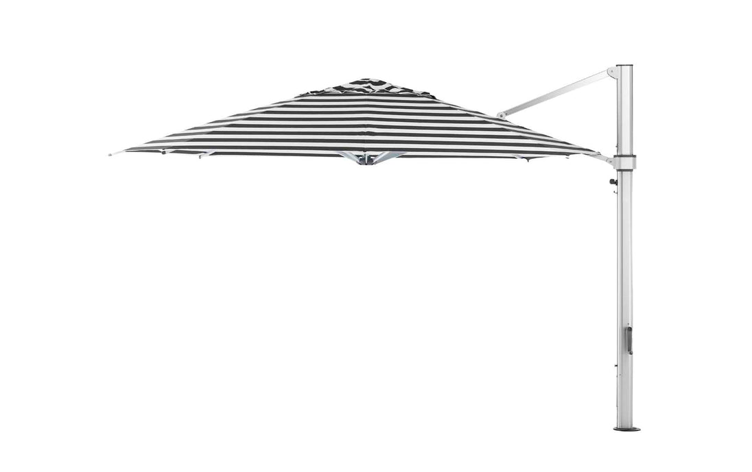 A side view of the Ultra Cantilever Umbrella - 13 Octagon by Ledge Lounger features a large black-and-white striped canopy with a cantilever design and sleek outdoor umbrella light. It is open, attached to a tall, sturdy metal stand extending into your patio space against a plain white background.