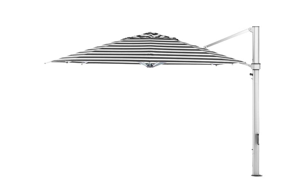 A side view of the Ultra Cantilever Umbrella - 13 Octagon by Ledge Lounger features a large black-and-white striped canopy with a cantilever design and sleek outdoor umbrella light. It is open, attached to a tall, sturdy metal stand extending into your patio space against a plain white background.