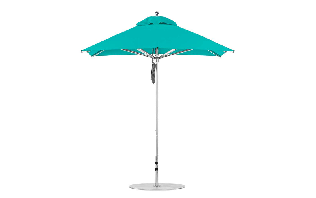 The Premier Aluminum Umbrella by Ledge Lounger features a 7.5 square canopy in turquoise with marine-grade fabrics, an aluminum pole, and a round base. Its vented top enhances airflow for wind resistance, making it ideal for garden or patio settings.