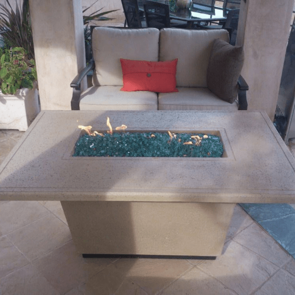 American Fyre Designs Cosmopolitan rectangle fire table with glass top and metal frame