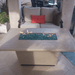 American Fyre Designs Cosmopolitan rectangle fire table with glass top and metal frame