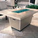 American Fyre Designs Cosmopolitan rectangle fire table with glass top and metal frame.