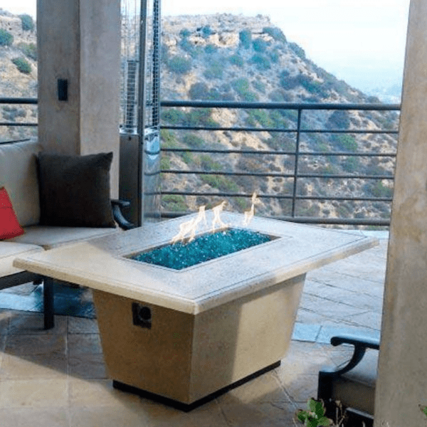 American Fyre Designs Cosmopolitan rectangle fire table with glass top and metal frame.
