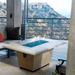 American Fyre Designs Cosmopolitan rectangle fire table with glass top and metal frame.