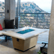 American Fyre Designs Cosmopolitan rectangle fire table with glass top and metal frame.