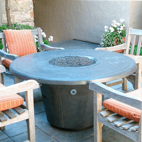American Fyre Designs Cosmopolitan round fire table with glass top and metal frame.