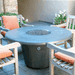 American Fyre Designs Cosmopolitan round fire table with glass top and metal frame.
