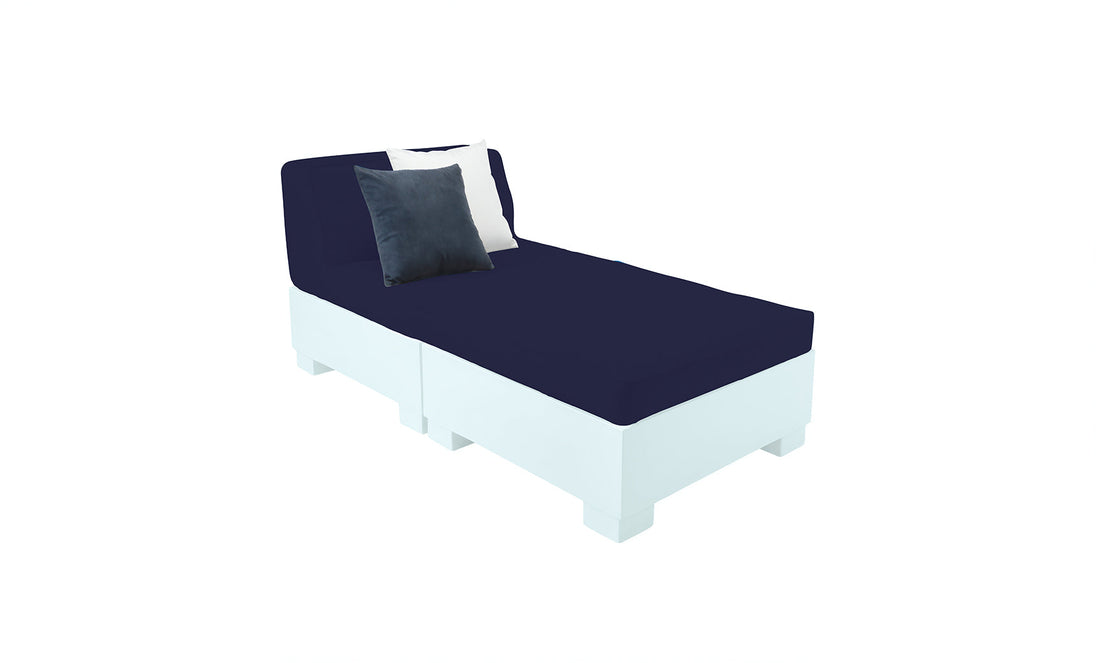 The Affinity 2 Piece Sun Chair by Ledge Lounger features a white base crafted from UV20 resin for outdoor durability, comes with two navy cushions, and a navy seat with decorative white and black pillows set against a plain white background.