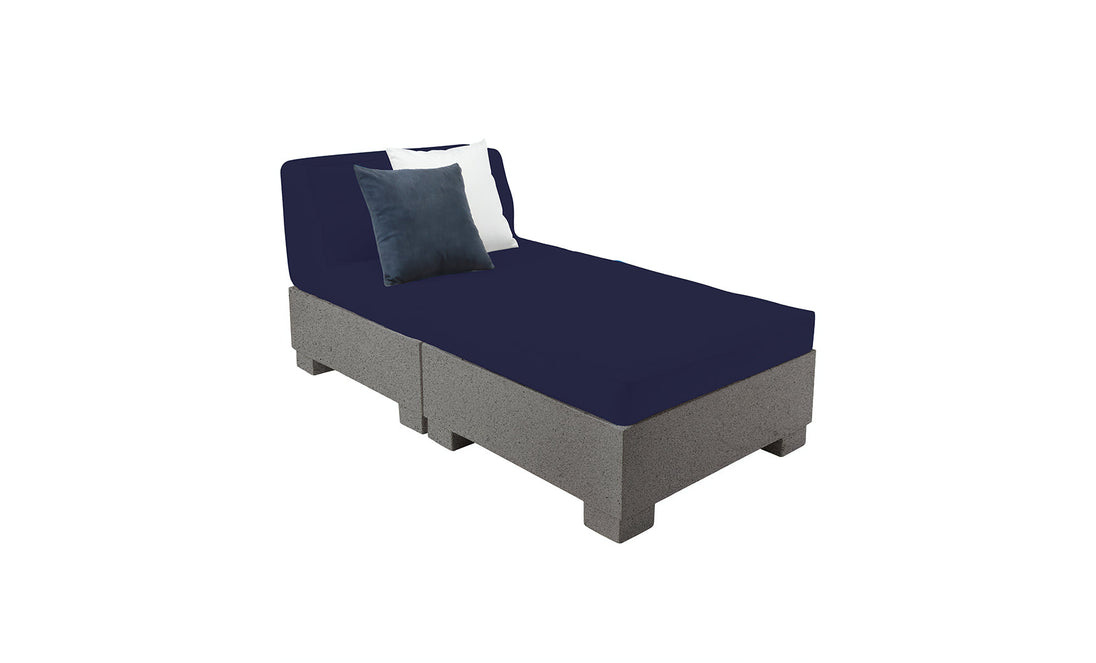 A gray platform bed with a dark blue mattress and two pillows, white and dark blue, is elegantly arranged. Its minimalist design mirrors the sophistication of upscale outdoor furniture, offering an invitation akin to a Ledge Lounger Affinity 2 Piece Sun Chair basking in sunlight.