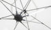 Close-up of the underside of a white umbrella with metal spokes radiating from a central hub. A Ledge Lounger Umbrella Light is attached to one spoke, creating a soft glow against the matching fabric background, ideal for an inviting patio setting.