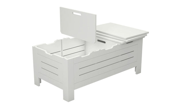 The Ledge Lounger Mainstay Storage Coffee Table is a white wooden box with internal compartments and a partially open slatted lid with a handle. Serving as chic storage, it elegantly stands on four legs.